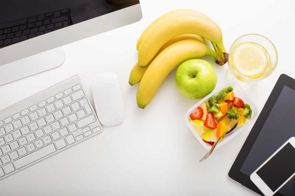banana and apple snacks on a desk