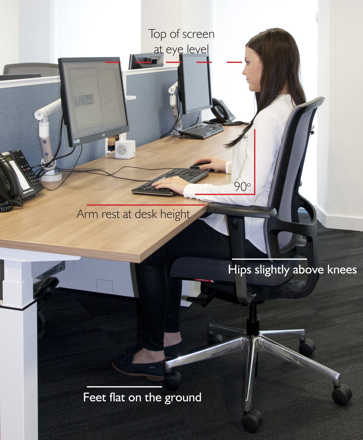 woman correcting seated desk height for better posture and ergonomics