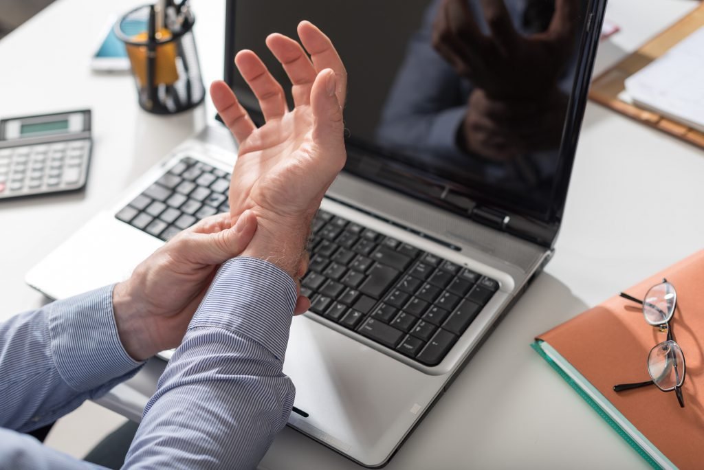 business man holding his wrist pain from typing